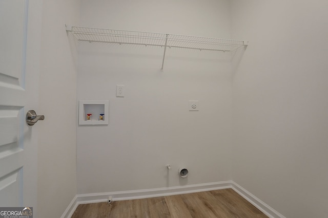 70 Trinity Ln, Covington, GA 30016 - laundry room featuring electric dryer hookup, washer hookup, wood finished floors, and hookup for a gas dryer