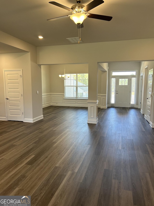 1179 Barrington Place Way, Macon, GA 31220 - unfurnished living room with a decorative wall, a chandelier, dark wood finished floors, healthy amount of natural light, and a ceiling fan