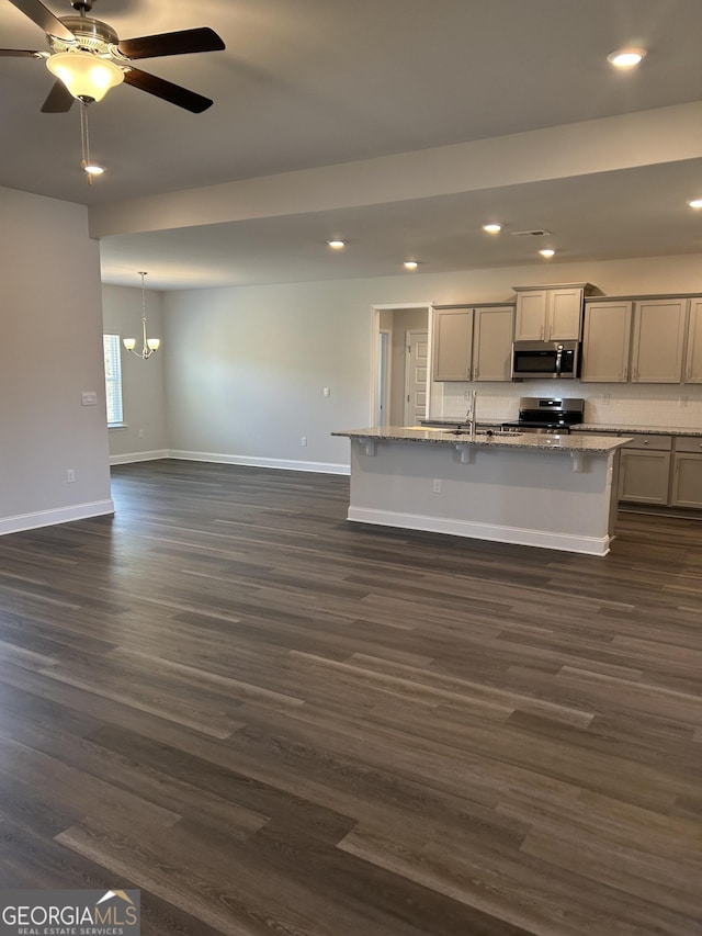 1179 Barrington Place Way, Macon, GA 31220 - kitchen with appliances with stainless steel finishes, recessed lighting, dark wood-type flooring, gray cabinets, and a chandelier
