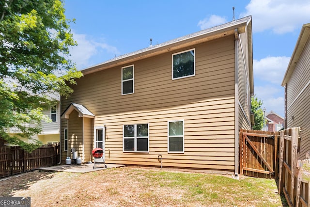 94 Torero Trl, Newnan, GA 30263 - rear view of property with a patio area, a fenced backyard, and a gate