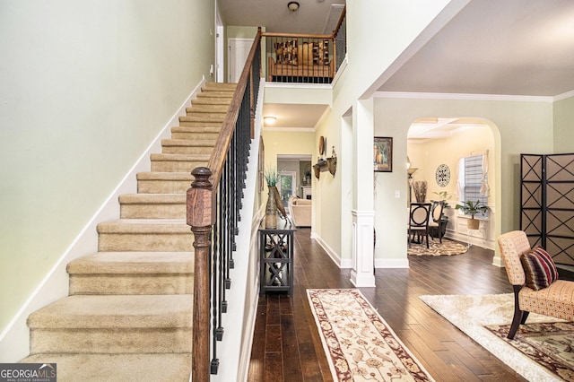94 Torero Trl, Newnan, GA 30263 - stairway with arched walkways, ornamental molding, and hardwood / wood-style floors