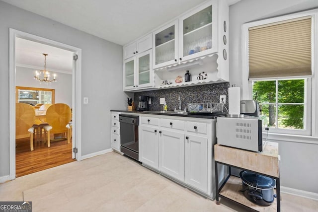 1809 Claron Ave, Conley, GA 30288 - kitchen featuring dishwasher, dark countertops, backsplash, a chandelier, and white cabinetry