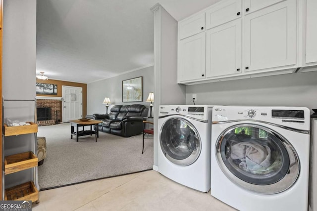 1809 Claron Ave, Conley, GA 30288 - laundry room featuring cabinet space, light carpet, independent washer and dryer, a brick fireplace, and light tile patterned floors