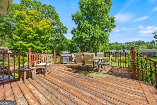 1809 Claron Ave, Conley, GA 30288 - deck featuring outdoor dining space, grilling area, and view of wooded area