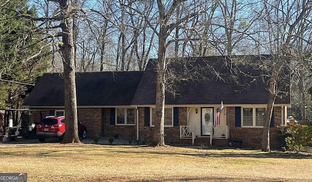 2203 Honeybee Creek Dr, Griffin, GA 30224 - cape cod house with brick siding, a front lawn, and a shingled roof