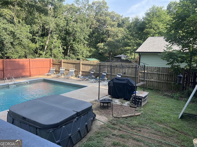 2203 Honeybee Creek Dr, Griffin, GA 30224 - view of pool featuring a hot tub, a gazebo, area for grilling, a fenced backyard, and a fire pit
