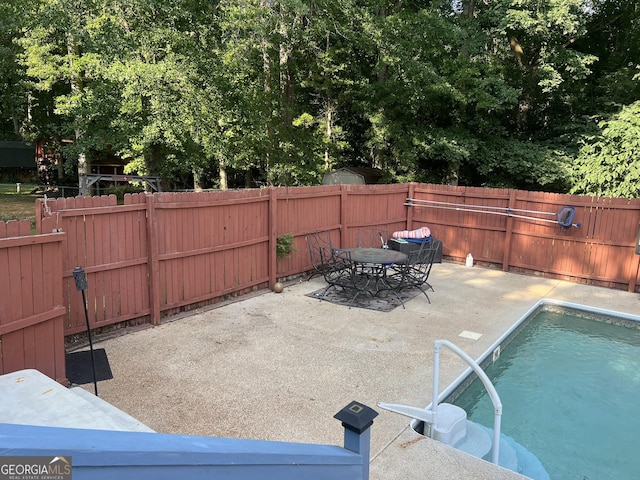 2203 Honeybee Creek Dr, Griffin, GA 30224 - view of swimming pool featuring a patio area, a fenced backyard, and outdoor dining space