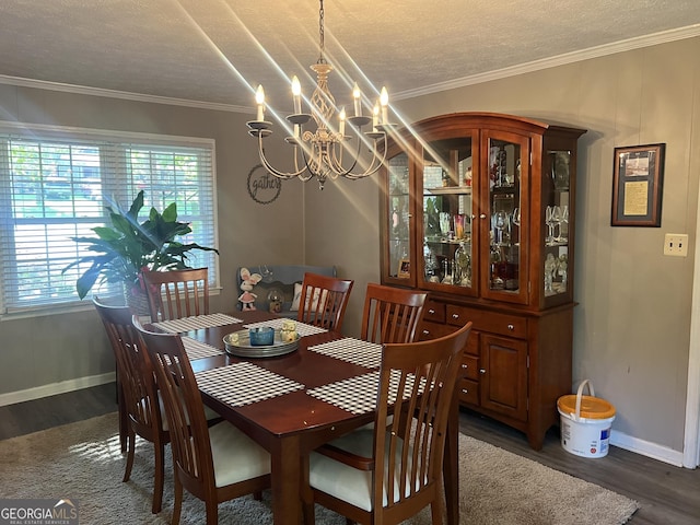 2203 Honeybee Creek Dr, Griffin, GA 30224 - dining room featuring dark wood-style floors, healthy amount of natural light, a chandelier, a textured ceiling, and crown molding