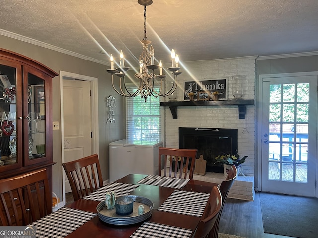 2203 Honeybee Creek Dr, Griffin, GA 30224 - dining room with a textured ceiling, wood finished floors, plenty of natural light, a chandelier, and a fireplace