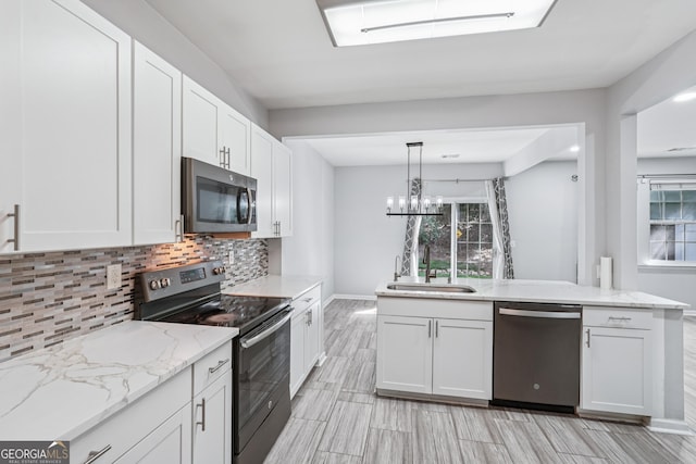 545 Windstone Trl, Alpharetta, GA 30004 - kitchen with stainless steel appliances, tasteful backsplash, white cabinets, light stone counters, and wood finish floors
