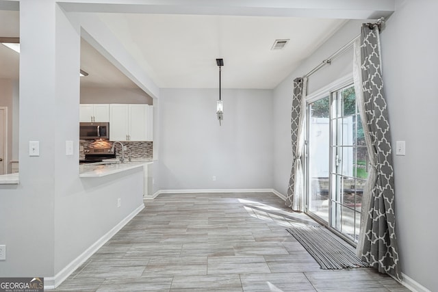 545 Windstone Trl, Alpharetta, GA 30004 - unfurnished dining area with baseboards