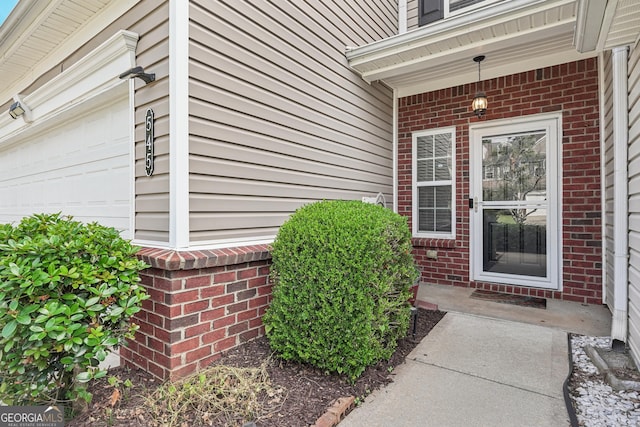 545 Windstone Trl, Alpharetta, GA 30004 - doorway to property featuring brick siding and an attached garage