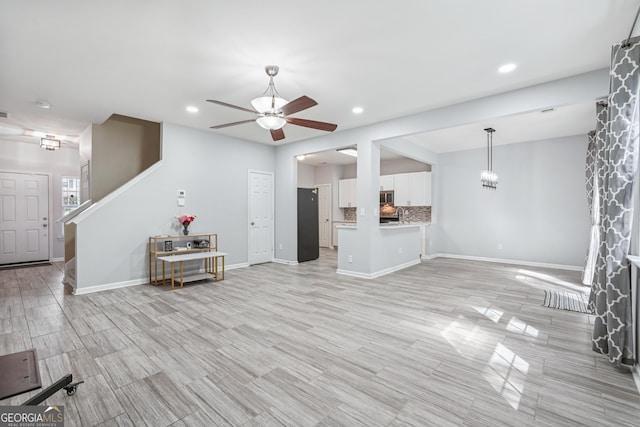 545 Windstone Trl, Alpharetta, GA 30004 - living area featuring a ceiling fan, recessed lighting, light wood-type flooring, and stairs