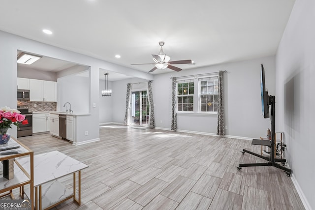545 Windstone Trl, Alpharetta, GA 30004 - living room featuring a ceiling fan, recessed lighting, and light wood-style flooring