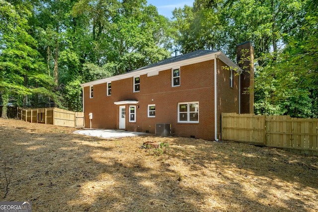 1783 Cheyenne Trl, Jonesboro, GA 30236 - back of property with a patio area, brick siding, and a chimney