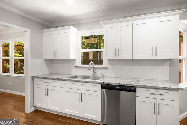 1783 Cheyenne Trl, Jonesboro, GA 30236 - kitchen with stainless steel dishwasher, healthy amount of natural light, white cabinets, decorative backsplash, and ornamental molding