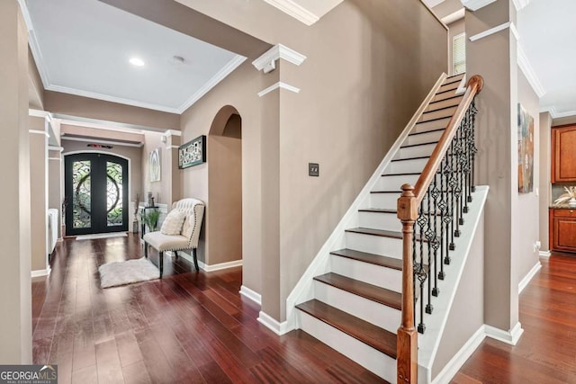 1146 Simonton Peak Way, Lawrenceville, GA 30045 - foyer featuring crown molding, dark wood finished floors, stairs, arched walkways, and radiator