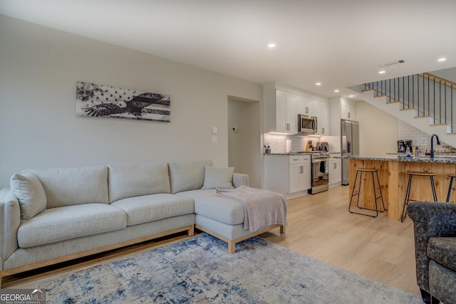 480 Mitchell Rd, Covington, GA 30014 - living area with light wood finished floors, recessed lighting, and stairway