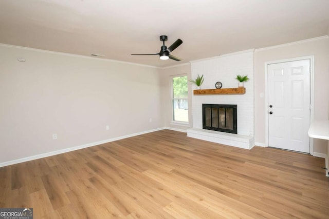 107 Runaway Point Rd, Savannah, GA 31404 - unfurnished living room with ceiling fan, crown molding, light wood finished floors, and a brick fireplace