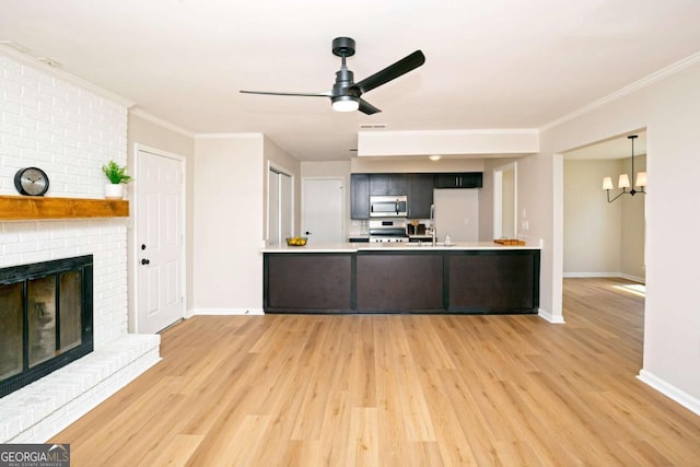 107 Runaway Point Rd, Savannah, GA 31404 - kitchen with stainless steel microwave, light wood-style flooring, ceiling fan, light countertops, and range with gas stovetop