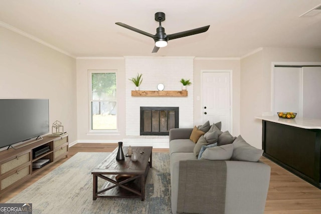 107 Runaway Point Rd, Savannah, GA 31404 - living area with wood finished floors, ornamental molding, a ceiling fan, and a fireplace