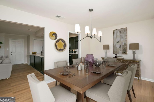 107 Runaway Point Rd, Savannah, GA 31404 - dining room featuring light wood-type flooring and a chandelier