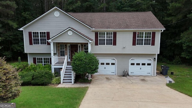264 Harbin Dr, Dallas, GA 30132 - view of front of property with concrete driveway, a garage, stairway, a porch, and a front yard