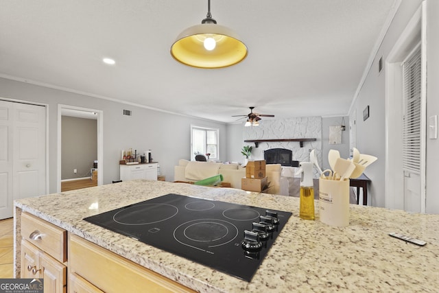 631 Valleybrook Rd, Savannah, GA 31419 - kitchen with black electric stovetop, ornamental molding, ceiling fan, a fireplace, and light stone counters