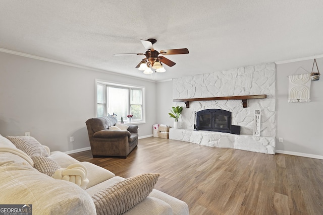 631 Valleybrook Rd, Savannah, GA 31419 - living room with crown molding, wood finished floors, ceiling fan, and a stone fireplace