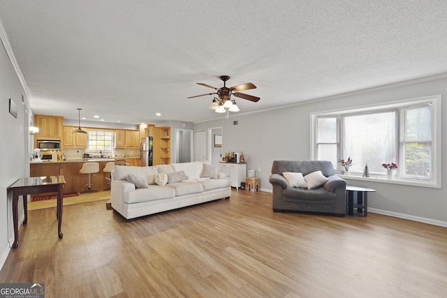 631 Valleybrook Rd, Savannah, GA 31419 - living room featuring light wood-style flooring, a ceiling fan, recessed lighting, ornamental molding, and a textured ceiling