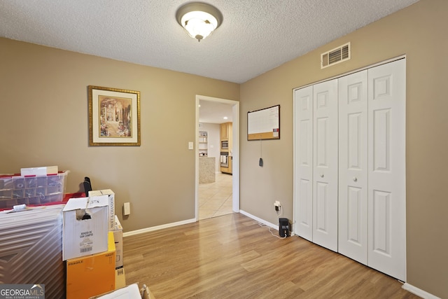 631 Valleybrook Rd, Savannah, GA 31419 - home office featuring light wood-style flooring and a textured ceiling