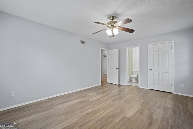 631 Valleybrook Rd, Savannah, GA 31419 - unfurnished bedroom with wood finished floors, connected bathroom, a textured ceiling, and a ceiling fan