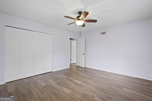 631 Valleybrook Rd, Savannah, GA 31419 - unfurnished bedroom featuring wood finished floors, a closet, and a ceiling fan