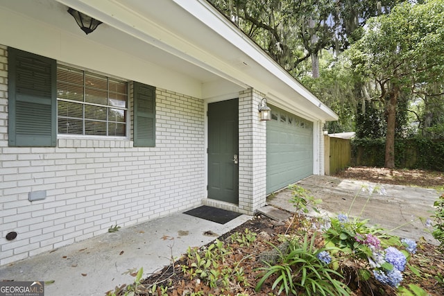 631 Valleybrook Rd, Savannah, GA 31419 - view of exterior entry featuring brick siding, driveway, and a garage