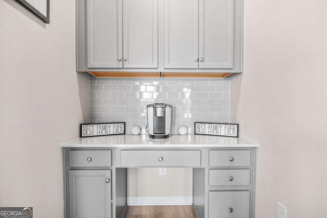 1049 Bodega Loop, Locust Grove, GA 30248 - bar area featuring backsplash and wood finished floors