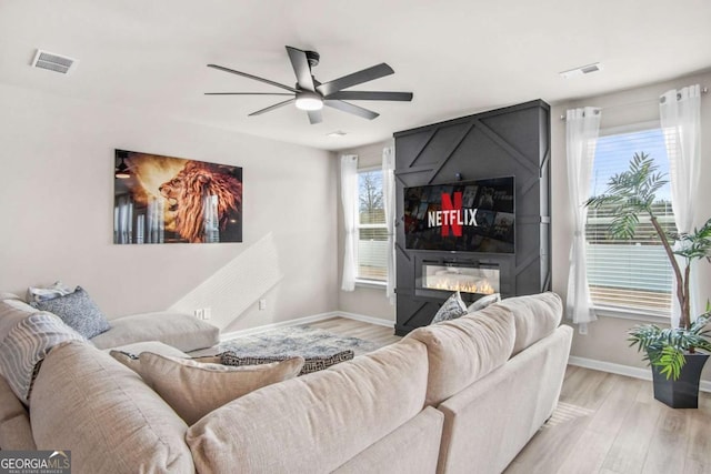 1049 Bodega Loop, Locust Grove, GA 30248 - living area featuring a ceiling fan, light wood-style floors, and a fireplace