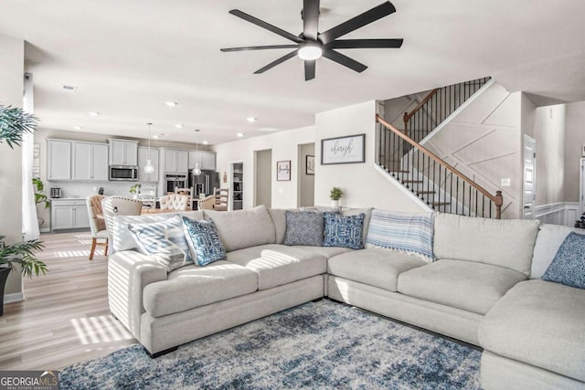 1049 Bodega Loop, Locust Grove, GA 30248 - living area featuring ceiling fan, light wood-style floors, stairway, and recessed lighting