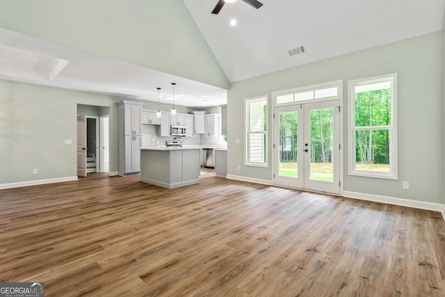 148 David Elder Rd, Griffin, GA 30223 - unfurnished living room featuring healthy amount of natural light, a ceiling fan, light wood-type flooring, high vaulted ceiling, and recessed lighting