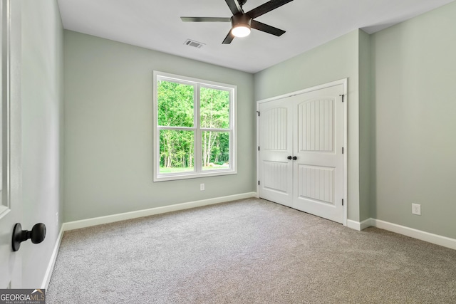 148 David Elder Rd, Griffin, GA 30223 - unfurnished bedroom featuring carpet flooring, a closet, and a ceiling fan