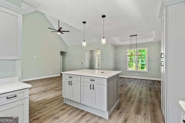 148 David Elder Rd, Griffin, GA 30223 - kitchen featuring light wood finished floors, a ceiling fan, open floor plan, pendant lighting, and light countertops