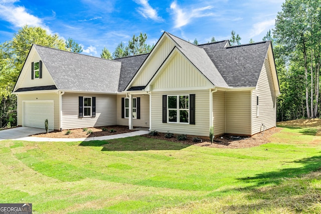 148 David Elder Rd, Griffin, GA 30223 - view of front of house with a garage, a front lawn, a shingled roof, and board and batten siding
