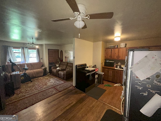 1551 Vaughn Rd, Griffin, GA 30223 - kitchen featuring freestanding refrigerator, light wood-style floors, a ceiling fan, brown cabinetry, and washer / dryer