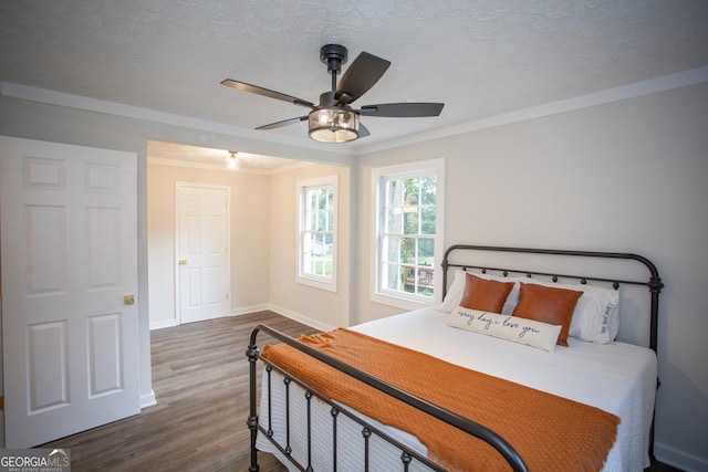 235 Cindy St, Jackson, GA 30233 - bedroom with dark wood finished floors, crown molding, a textured ceiling, and a ceiling fan