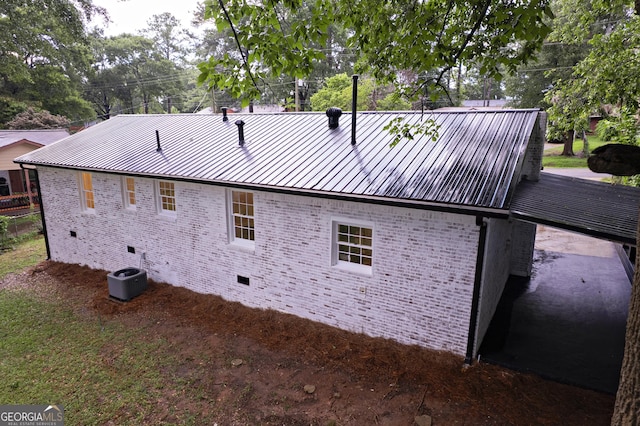 235 Cindy St, Jackson, GA 30233 - view of side of home with crawl space, brick siding, and a metal roof