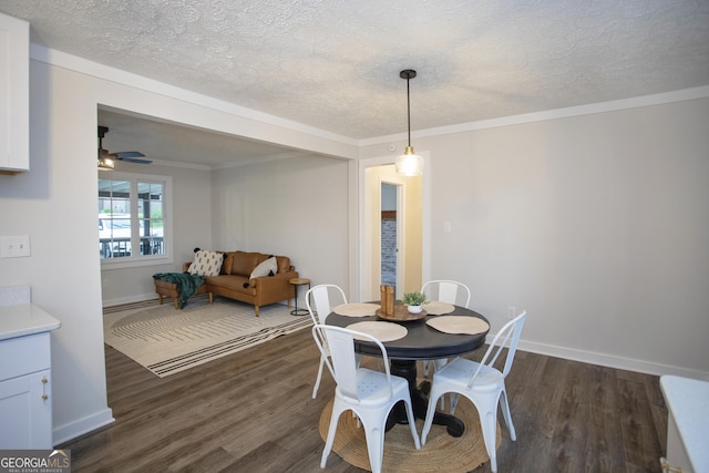 235 Cindy St, Jackson, GA 30233 - dining area featuring dark wood finished floors, ceiling fan, a textured ceiling, and ornamental molding