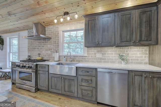 198 Hillcrest Dr, Calhoun, GA 30701 - kitchen featuring stainless steel appliances, wall chimney range hood, light wood finished floors, tasteful backsplash, and light stone countertops