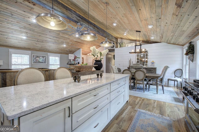 198 Hillcrest Dr, Calhoun, GA 30701 - kitchen featuring wood ceiling, vaulted ceiling, white cabinetry, range, and a center island