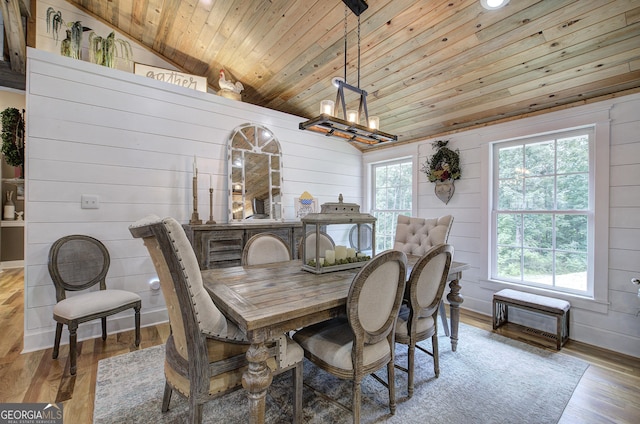 198 Hillcrest Dr, Calhoun, GA 30701 - dining space with wooden ceiling, wood walls, wood finished floors, a chandelier, and lofted ceiling