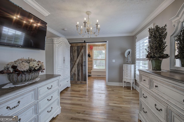 198 Hillcrest Dr, Calhoun, GA 30701 - interior space featuring a barn door, a chandelier, light wood finished floors, a textured ceiling, and crown molding