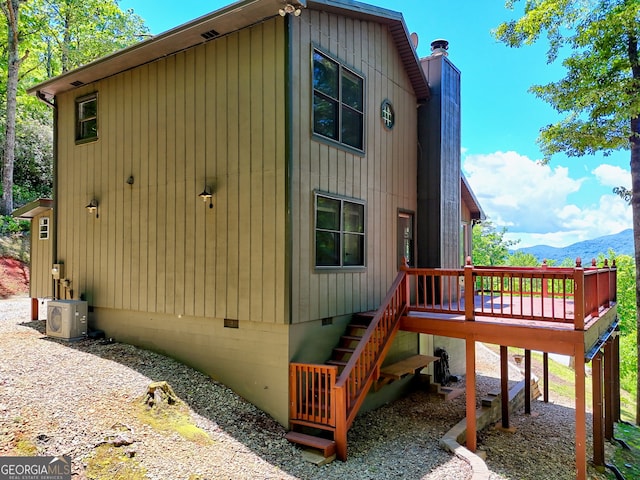 967 Saddle Gap Dr, Clayton, GA 30525 - view of home's exterior with crawl space, a chimney, a deck with mountain view, and stairway